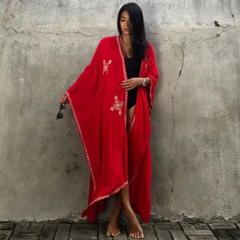 A vibrant red rayon embroidered holiday sun protection cardigan with intricate white embroidery and beaded trim