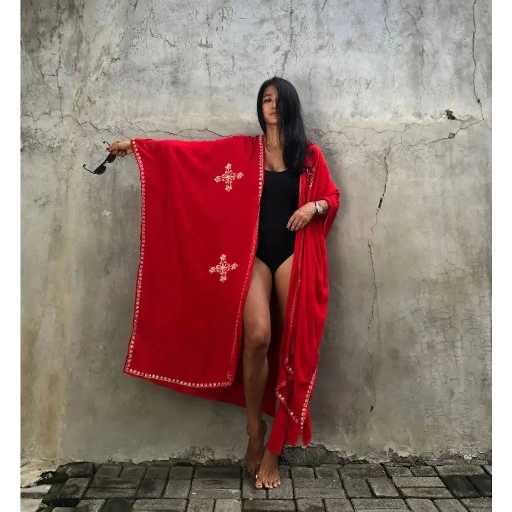A vibrant red rayon embroidered holiday sun protection cardigan with long sleeves and white cross detailing