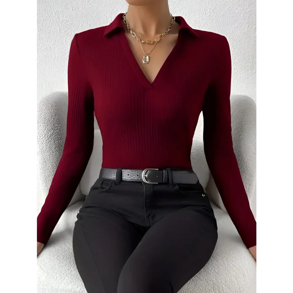 A deep red ribbed knit long sleeve polo top with collar and v neck featuring a fashionable slim fit design