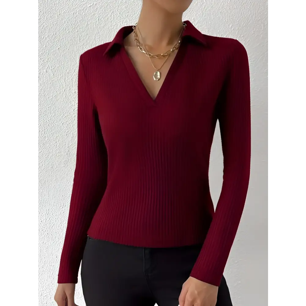 A red ribbed knit fashionable slim fit polo top with a collar and long sleeves in rich burgundy color