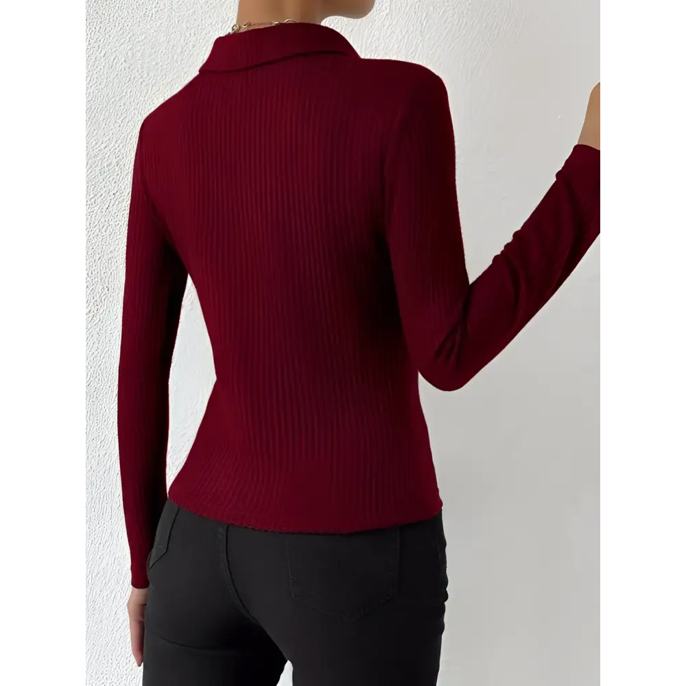 A fitted long-sleeved maroon red ribbed knit top with collar showcasing a fashionable slim fit polo design