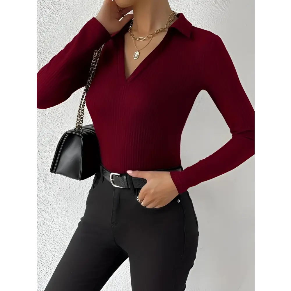 A deep red ribbed knit long sleeve polo top with collar and v neck featuring a fashionable slim fit design