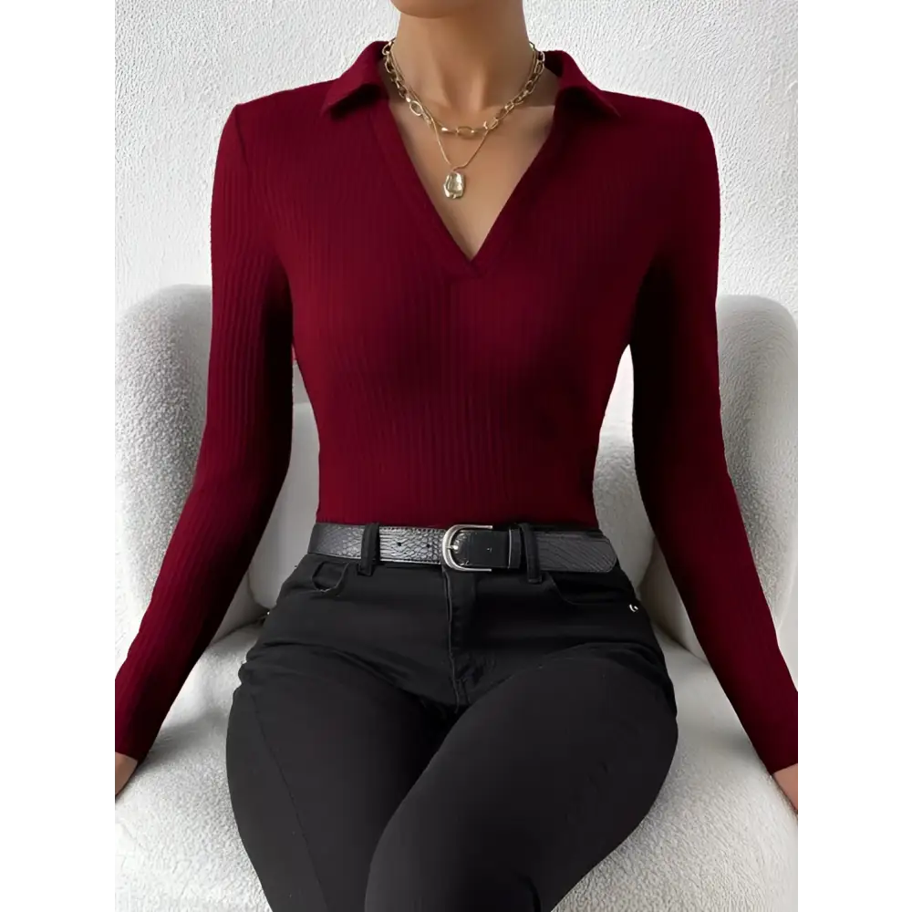 A fitted long-sleeved red ribbed knit fashionable slim fit polo top with v-neckline and ribbed texture