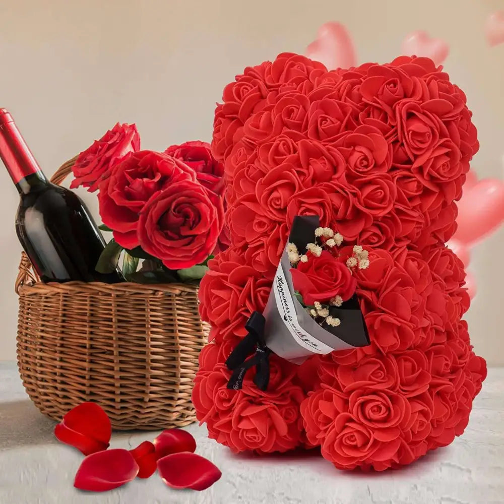 A red rose bear crafted from artificial flowers with a soft texture holding a small bouquet in an eternal flower gift box