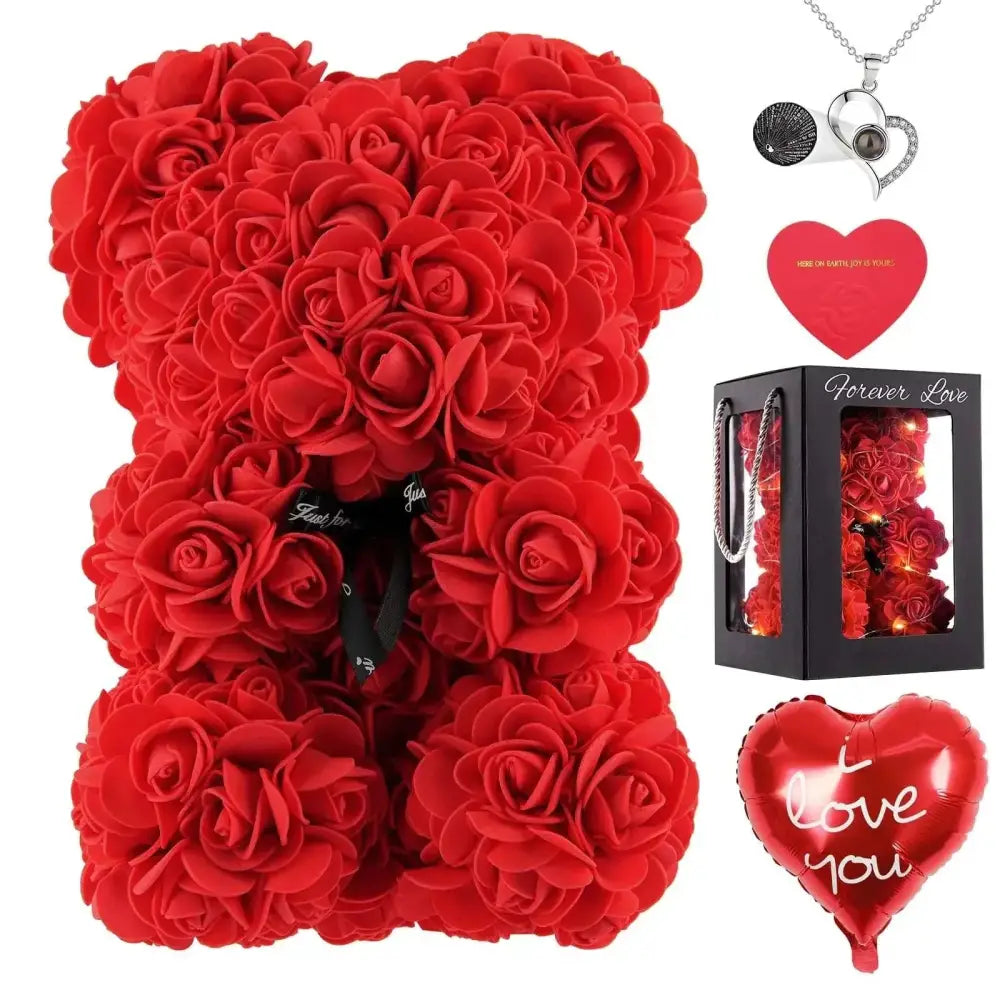 A red rose bear teddy bear made of plush artificial petals with a black ribbon and heart balloon accessory