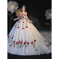 A voluminous white ball gown wedding dress with red rose embroidery and lace detailing featuring bride bra trailing