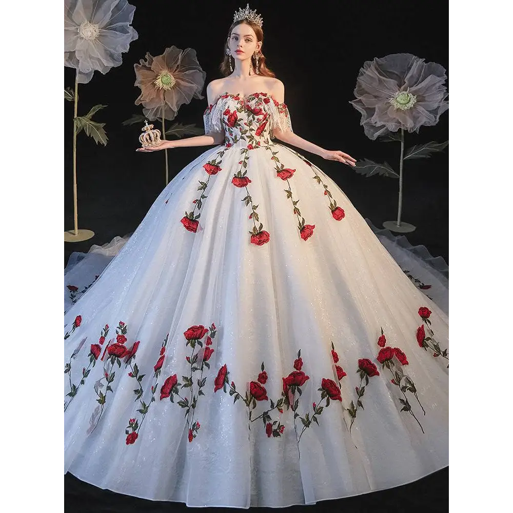 A white off-the-shoulder ball gown with red rose embroidery lace detailing for temperament bride bra wedding dress