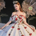 A white off-the-shoulder ball gown with red rose embroidery and lace detailing for temperament bride bra wedding dress