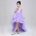 A young girl wears a lavender ruffled girls dress wedding gown with a sparkling bodice and matching floral headpiece