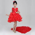 A vibrant red sleeveless wedding flower girl dress with fitted bodice and voluminous ruffled girls dress skirt