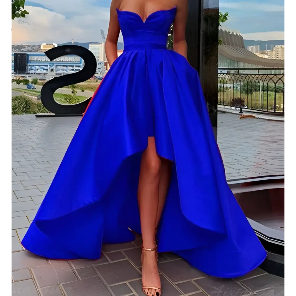A vibrant royal blue satin ladies evening dress with a strapless sweetheart neckline and high low hemline