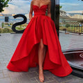 A vibrant red satin ladies evening dress with strapless sweetheart neckline and high low hemline