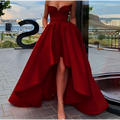 A vibrant red satin strapless ladies evening dress with a sweetheart neckline and a high low hemline