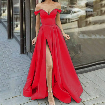A vibrant red satin large swing split sleeveless gown with an off-the-shoulder fitted bodice and high slit