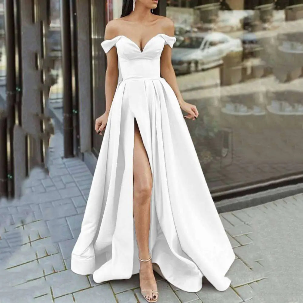 White satin off-the-shoulder ball gown with high slit and fitted bodice resembling red satin large swing split sleeveless gown