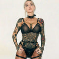 Black sheer bodysuit with intricate metallic chain detailing and central pendant for red spiked leather crown stage costumes performance