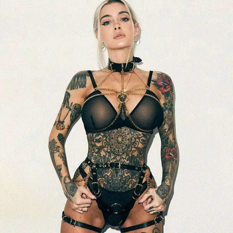 Black sheer bodysuit with intricate metallic chain detailing and central pendant for red spiked leather crown stage costumes performance