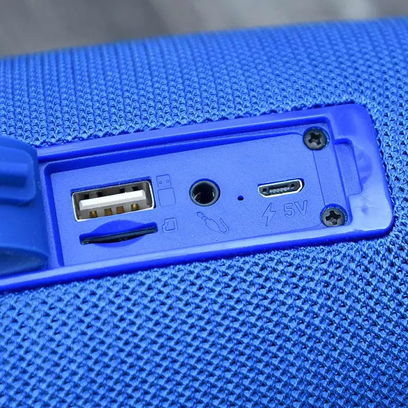 Blue textured fabric wireless bluetooth speaker with usb and 5v charging ports on the back panel featuring bluetooth audio