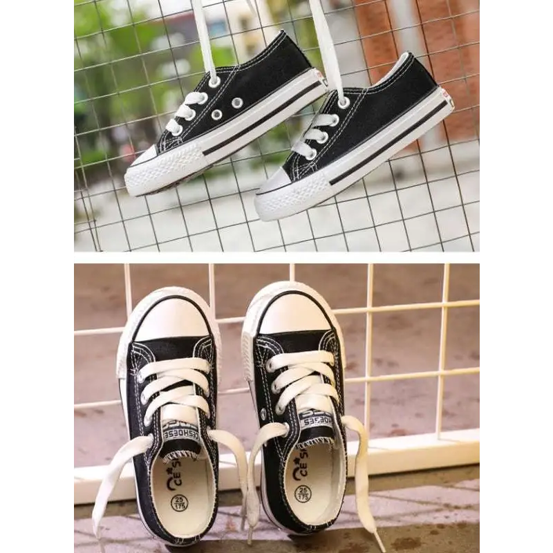 Black canvas low-top sneakers with white rubber soles and toe caps for casual shoes student and children’s clothing