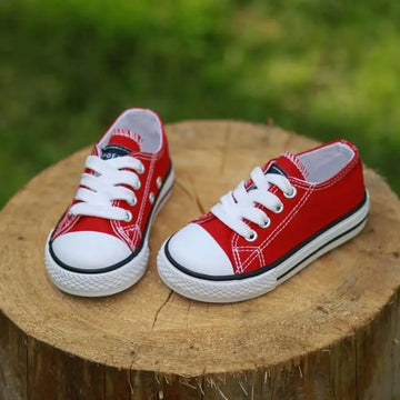 Red toddler canvas casual shoes student style featuring white laces toe caps and rubber soles with black piping