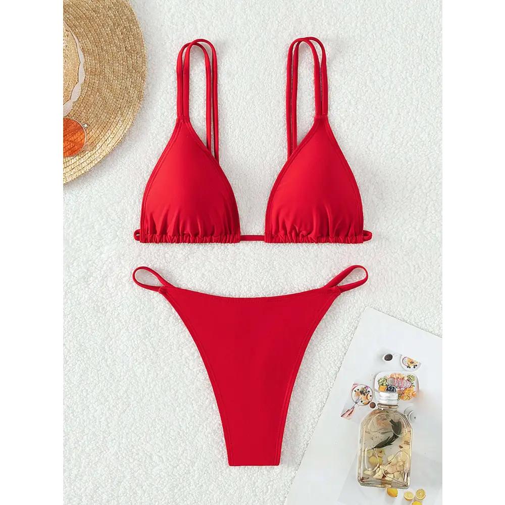 A vibrant red triangle cup halter bikini with thin straps and a matching high-cut bottom in halter bikini design