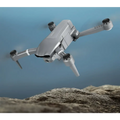 Silver gray folding drone with sleek design and black propeller guards featuring mobile phone control and gps positioning