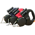 Retractable double dog leash with flashlight in navy red and black featuring matching handles and metallic clasps for walk two dogs