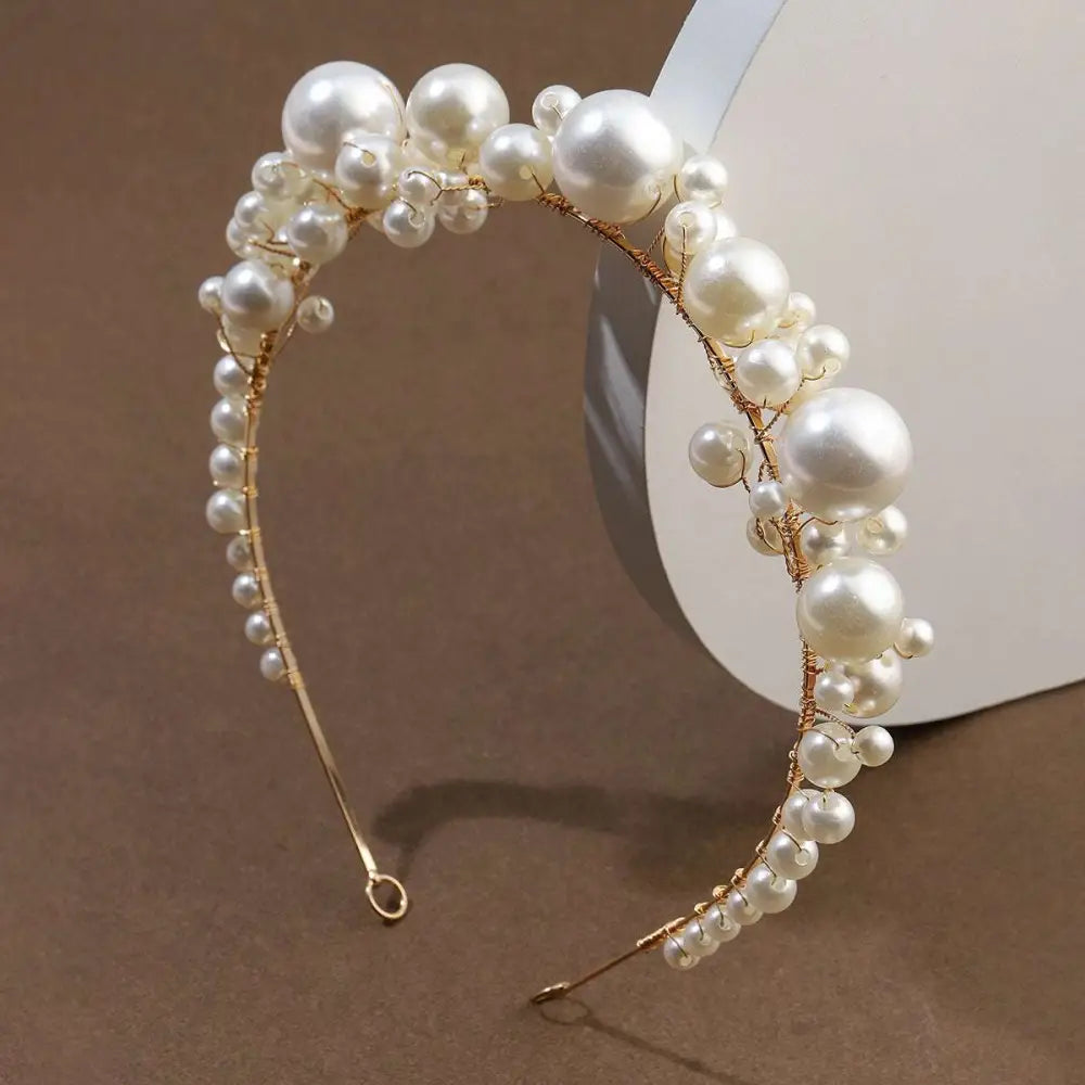 Elegant gold-toned retro bridal headdress featuring a cascading arrangement of cream and white pearls simple pearl headband