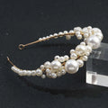 A delicate gold-toned retro bridal headdress featuring a simple pearl headband with cascading white pearls in varying sizes