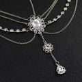 Silver ornate flower drops headpiece with retro diamond embellishments and layered crystal chains with central gemstone
