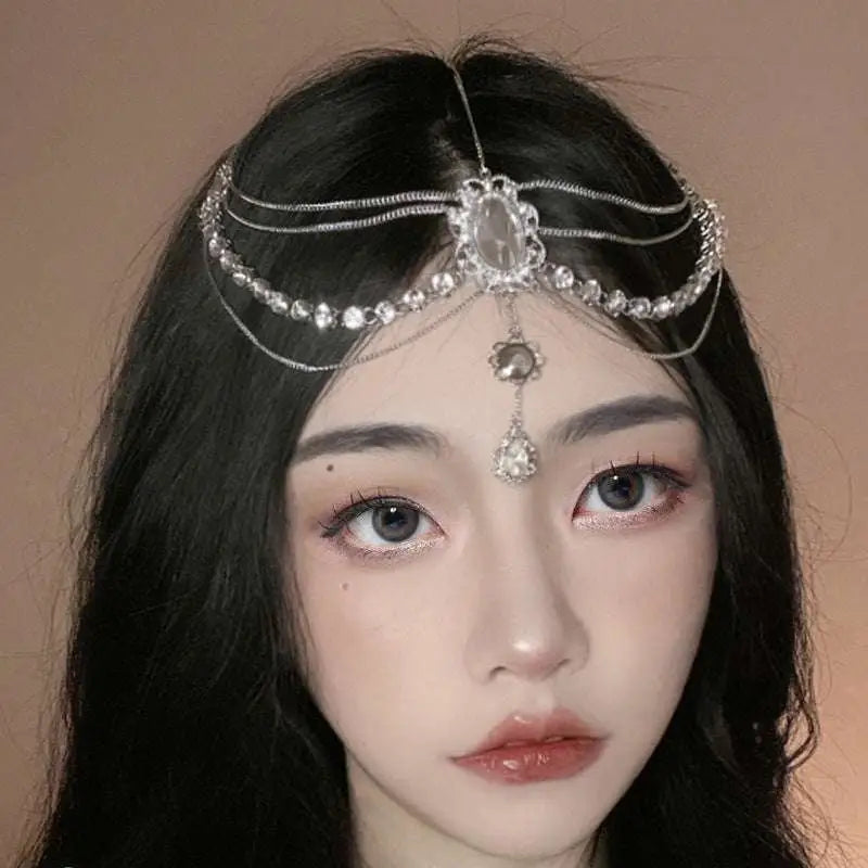 A silver retro diamond embellishments flower drops headpiece with rhinestones, central oval crystal, and dangling charms