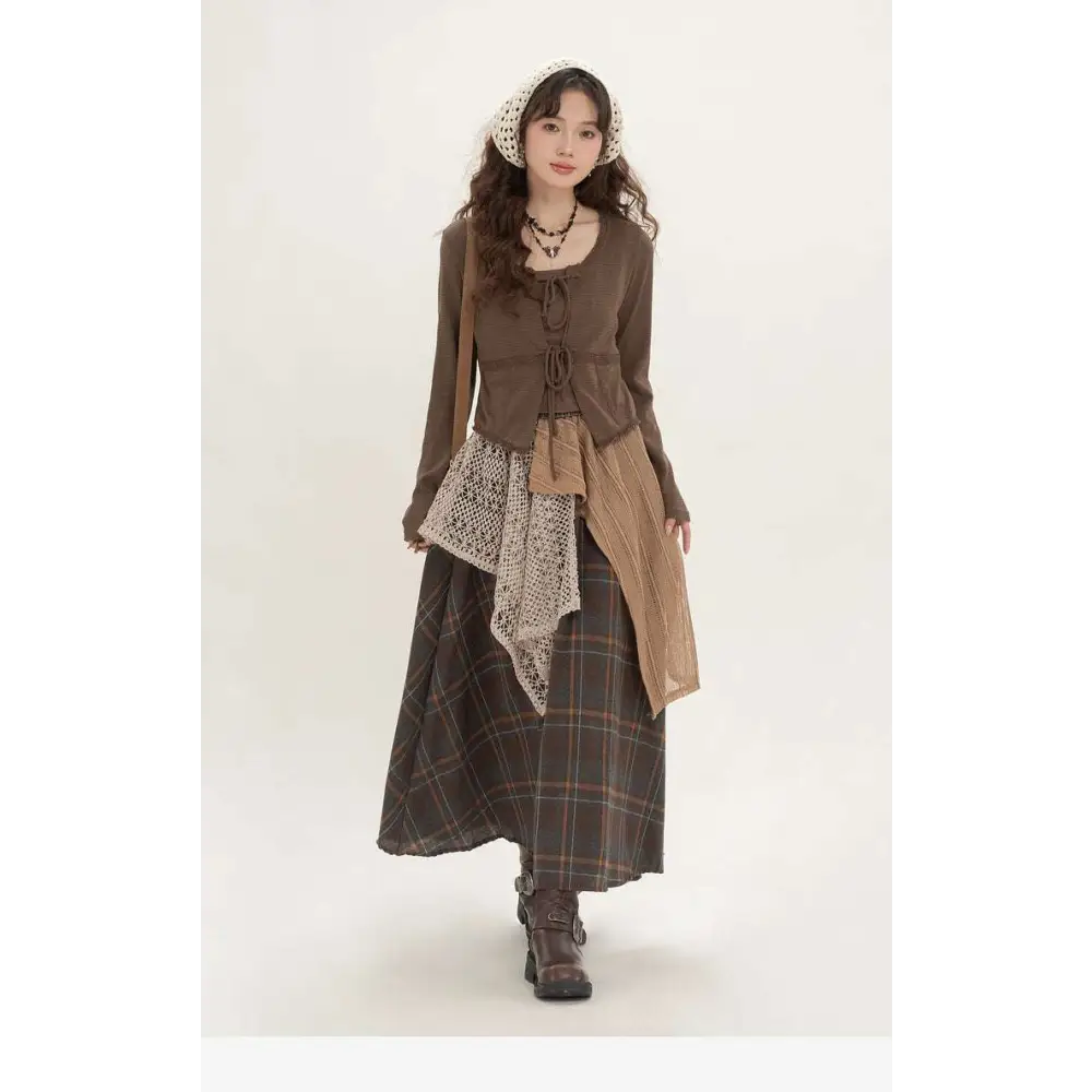 A retro minority irregular plaid a line skirt with elastic waistband paired with off-white crochet overlay cardigan and boots