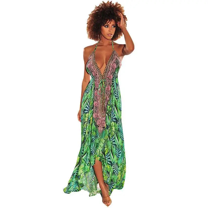 A vibrant green tropical leaf print retro pattern sexy halter dress with a v neck and pink beaded detailing