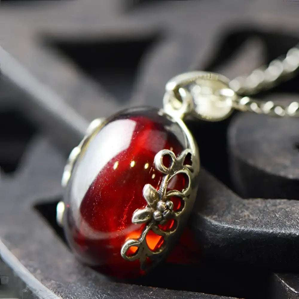 A retro red zircon glass pendant with intricate s925 sterling silver filigree in a silver jewelry set