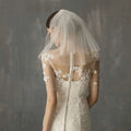 Retro short wedding lace floral veil in sheer white lace with delicate floral appliqués on the back and shoulders