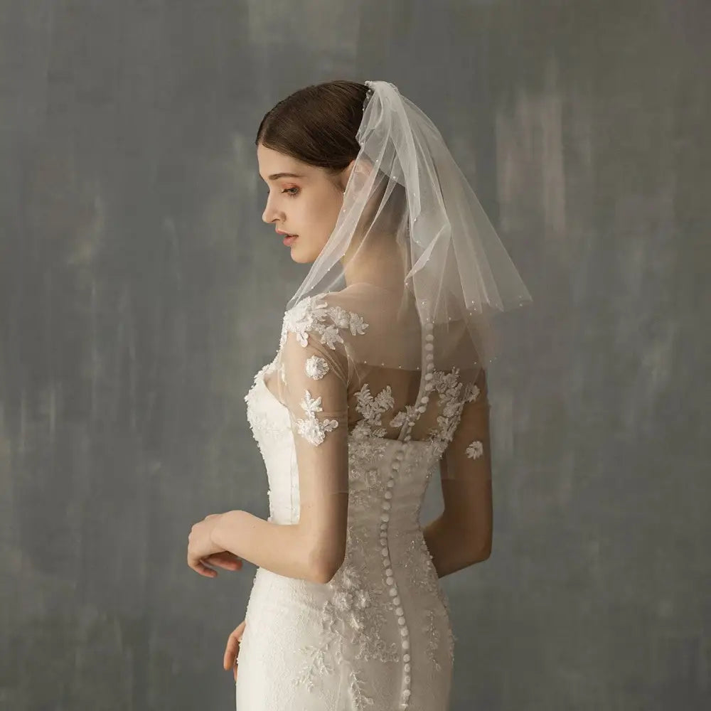 A retro short wedding lace floral veil in sheer white with delicate embroidery as a wedding bride headdress