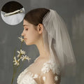Retro short wedding lace floral veil in white tulle with pearl embellishments and a sleek silver hair clip