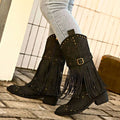 Black suede cowboy boots with gold-tone studs and fringe detailing for retro winter fashion style