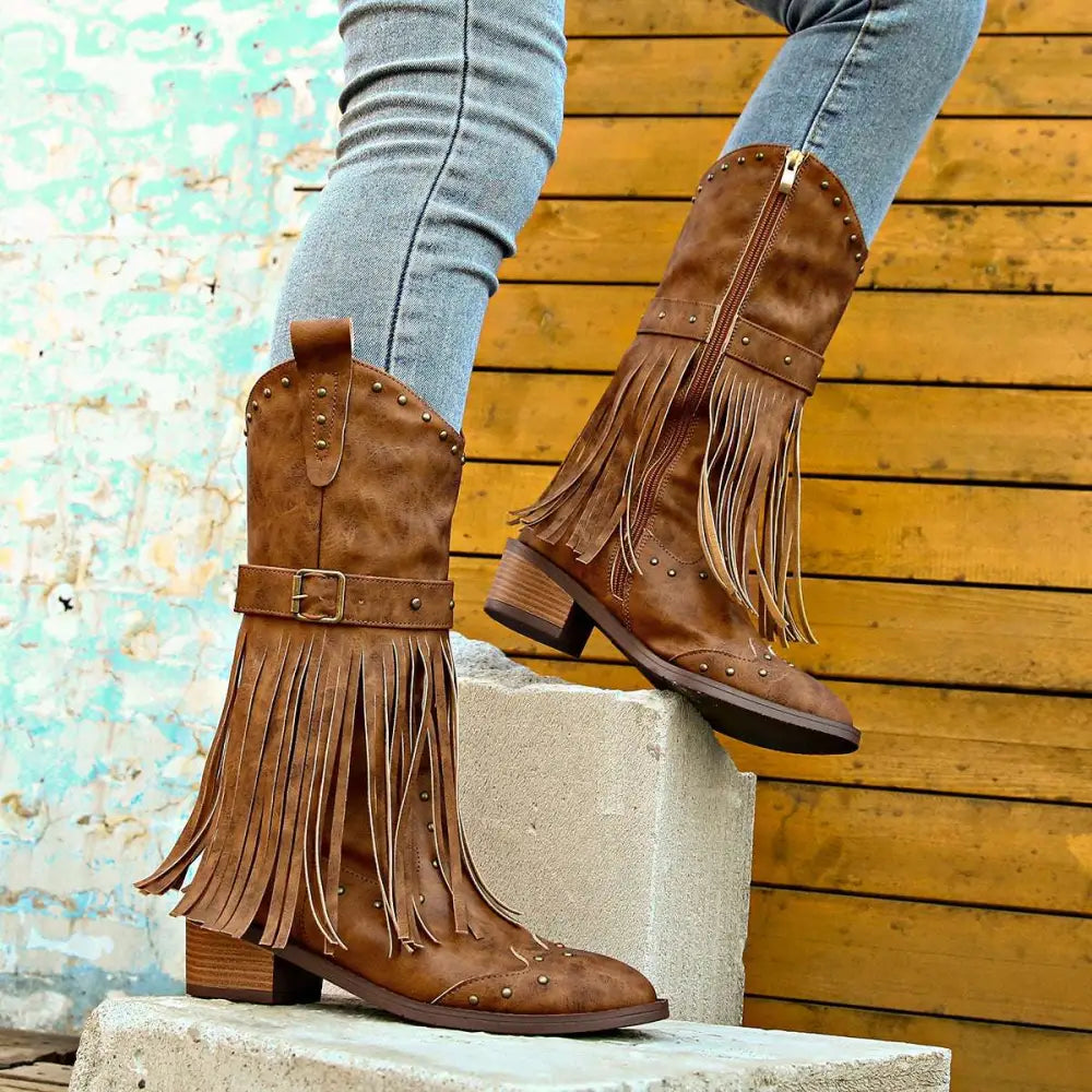 Brown suede cowboy boots with fringe and gold-tone studs featuring retro winter fashion style