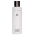 A sleek white bottle of revitalash cosmetics thickening shampoo with glossy black cap for scalp therapy use
