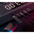 Black digital audio player with illuminated display and multiple ports beside rgb gaming keyboard with wireless bluetooth speaker