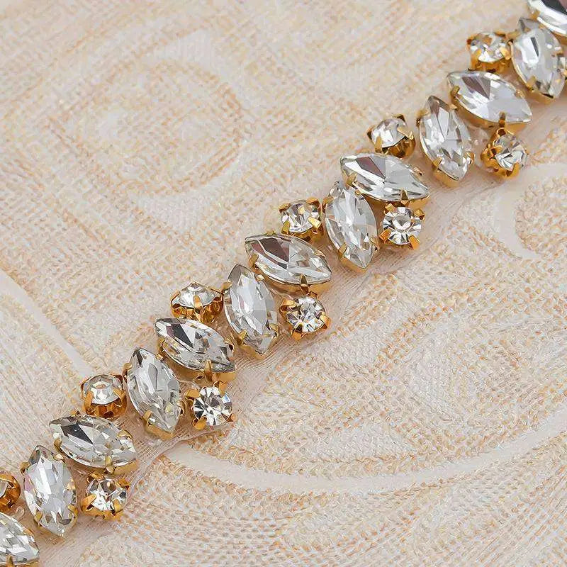 A sparkling gold-trimmed rhinestone applique wedding sash with clear marquise and round crystals for dress waist jewelry