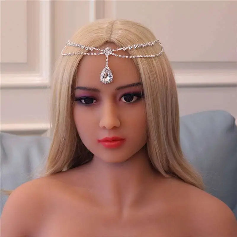 A silver rhinestone headdress featuring a sparkling teardrop crystal pendant as a drop bridal chain accessory