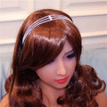 A silver rhinestone headdress with multiple drop bridal chain rows elegantly worn on a model’s brown hair