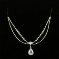 A gold-toned drop bridal chain with sparkling clear crystals and a teardrop pendant for bridal or silver rhinestone headdress use