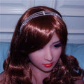 A silver rhinestone headdress with a simple water drop bridal chain worn by a figure with long brown hair