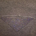 A triangular black mesh face mask with densely packed sparkling rhinestones and a delicate silver chain from rhinestone metal flash