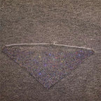 A triangular black mesh face mask with densely packed sparkling rhinestones and a delicate silver chain from rhinestone metal flash