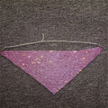 A shimmering purple rhinestone metal flash mesh face mask with triangular design and delicate silver chain detailing