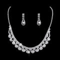 A sparkling silver rhinestone zircon water drop necklace with floral design and matching drop earrings set